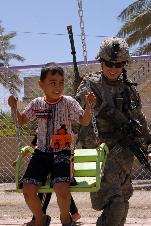 BAGHDAD - "It makes my day when I see a smile on a kids face," said Spc. Edward Suarez, a tanker from Phelan, Calif., assigned to Company B, 2nd Battalion, 5th Cavalry Regiment, 1st Brigade Combat Team, 1st Cavalry Division, as he shares a smile...