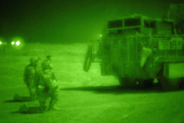 TAJI, Iraq - From behind their Stryker vehicle, Sgt. Ben Behringer  (at right) of Lake City, Pa., Company B, 1st Battalion, 112th Infantry Regiment, 56th Stryker Brigade Combat Team, and another Soldier scan the Iraqi countryside north of Camp...
