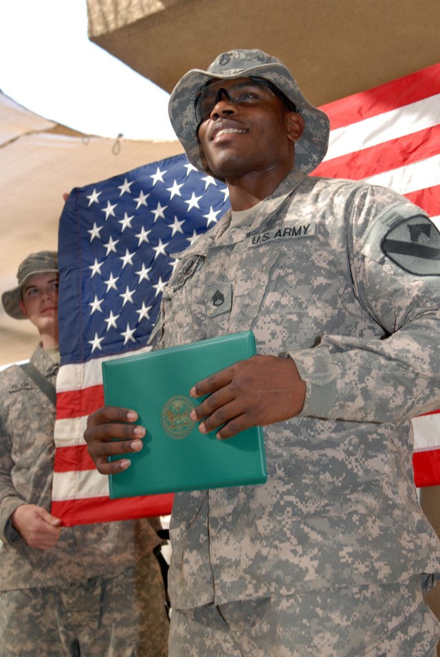 BAGHDAD - Staff Sgt. Martin Williams, an intelligence analyst from Portsmouth, Va., assigned to Headquarters and Headquarters Company, 2nd Battalion, 5th Cavalry Regiment, 1st Brigade Combat Team, 1st Cavalry Division, gives a speech after re-enlisti...