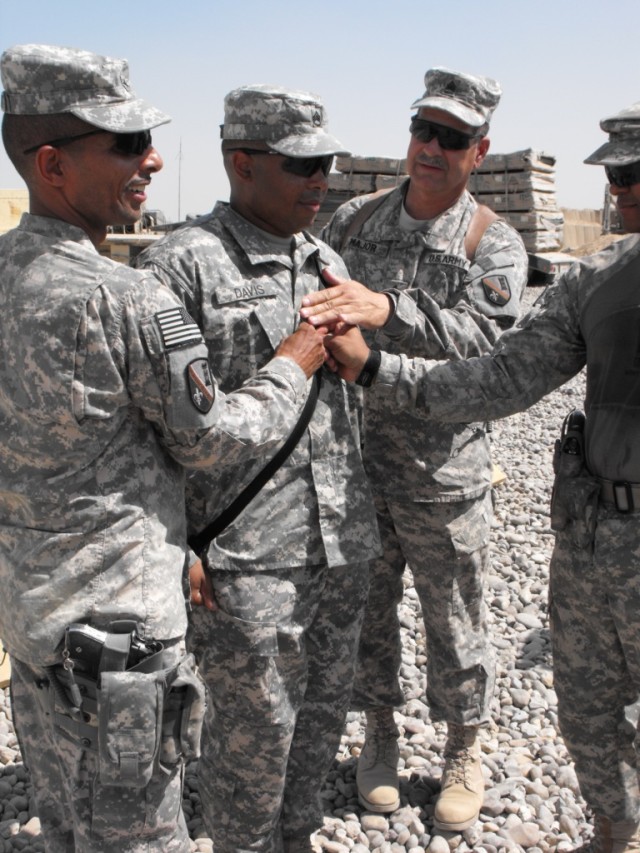 BAGHDAD- Staff Sgt. Edward Davis (center), Company B, 46th Engineer Combat Battalion (Heavy), 225th Engineer Brigade, gets promoted to sergeant first class by Brig. Gen. Owen Monconduit (left) and Command Sgt. Maj. Joe Major (right) at Combat...