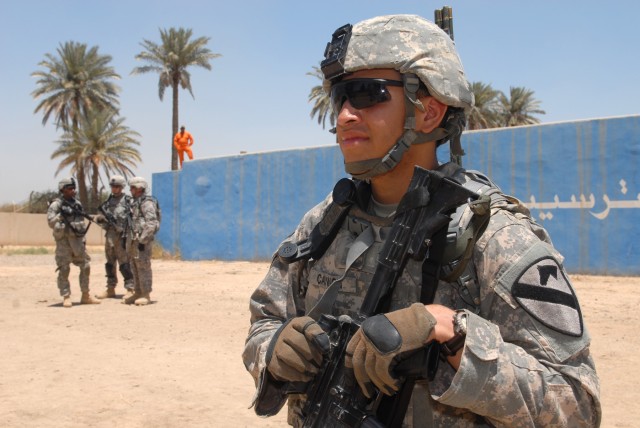 BAGHDAD - Pfc. Cameron Cannon of Dayton, Nev., a forward observer assigned to Headquarters and Headquarters Battery, 1st Battalion, 82nd Field Artillery Regiment, 3rd Brigade Combat Team, 82nd Airborne Division, pulls security, June 1, in front of...