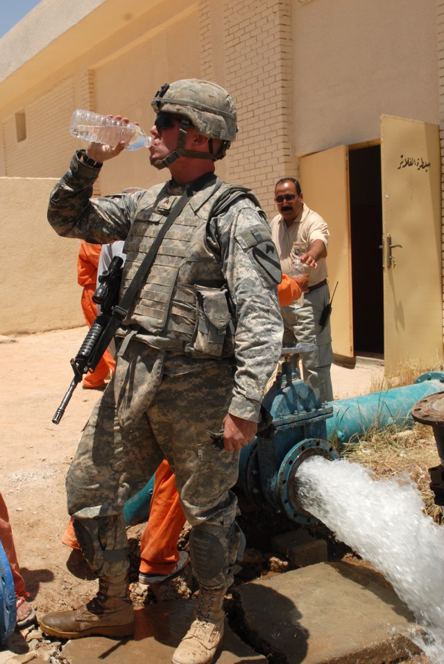 BAGHDAD - Sgt. James Brown of Binghampton, N.Y., a track vehicle mechanic assigned to Company G, 1st Battalion, 82nd Field Artillery Regiment, 3rd Brigade Combat Team, 82nd Airborne Division, takes a drink of water, June 1, from a valve he helped...
