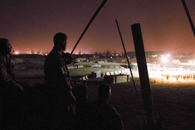 Soldiers of Detachment E, 50th Signal Company perch atop their Mine-Resistant, Ambush-Protected vehicle at a concert put on by Sevendust, a hard rock band from Atlanta. The Soldiers provided a quick reaction force for the concert on Forward...