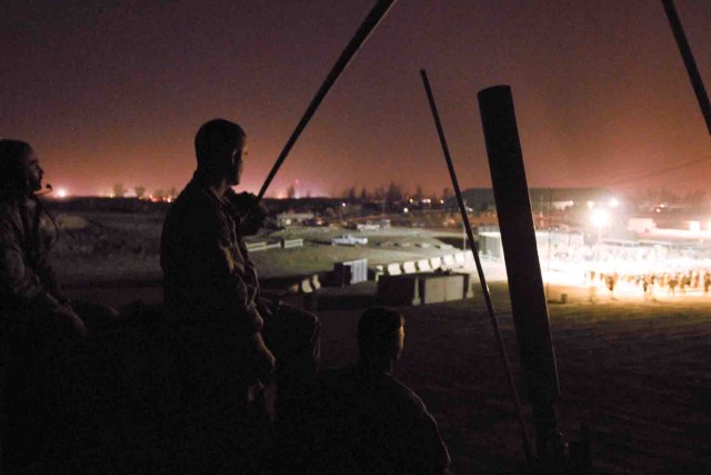 Soldiers of Detachment E, 50th Signal Company perch atop their Mine-Resistant, Ambush-Protected vehicle at a concert put on by Sevendust, a hard rock band from Atlanta. The Soldiers provided a quick reaction force for the concert on Forward Operating...