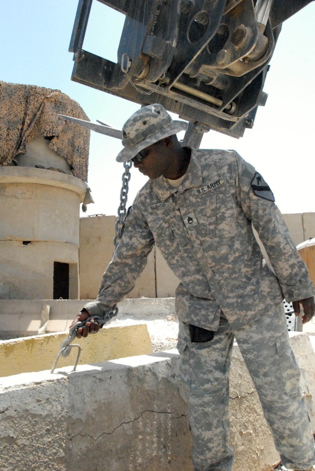 BAGHDAD -Staff Sgt. Terrell Washington, of Oklahoma City, Okla., noncommissioned officer in charge of the cooks with Company E, 1st Battalion, 5th Cavalry Regiment, attached to the 1st Brigade Combat Team, 1st Cavalry Division, attaches a forklift to...