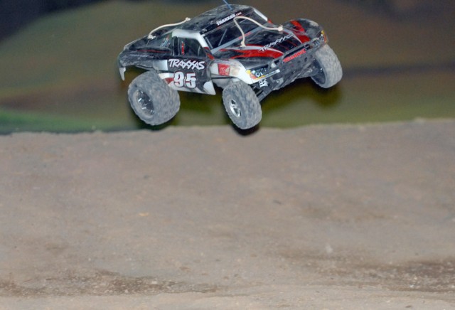 BAGHDAD - A remote control car catches air off a jump during a race held weekly between service members on Camp Liberty, Iraq. The dirt track, built roughly four years ago by service members stationed on the camp, is full of twist and turns to...