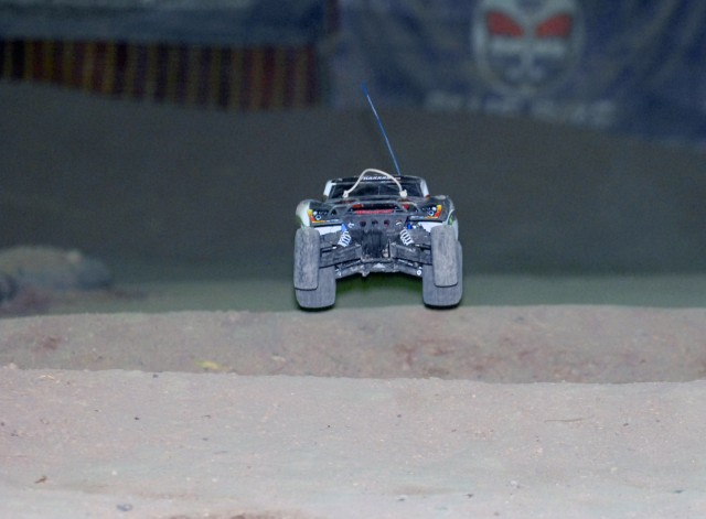 BAGHDAD - A remote control car catches air off a jump during a race held weekly between service members on Camp Liberty, Iraq. The dirt track, built roughly four years ago by service members stationed here, is full of twist and turns to test the...