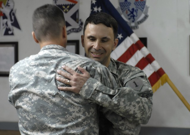 BAGHDAD - Col. Joseph Martin (left), a native of Dearborn, Mich., commander, 2nd Heavy Brigade Combat Team, 1st Infantry Division, Multi-National Division - Baghdad, hugs Lt. Col. Frank Tank, a native of Minot, N.D., intelligence officer-in-charge, 2...