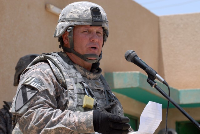 BAGHDAD - Maj. Jeffrey Schrick, a Fredrick, Okla., native and commander of 2nd Battalion, 8th Cavalry Regiment, 1st Cavalry Division, delivers a speech to local members of the community and the school staff at the Zoba Village High School, June 4....
