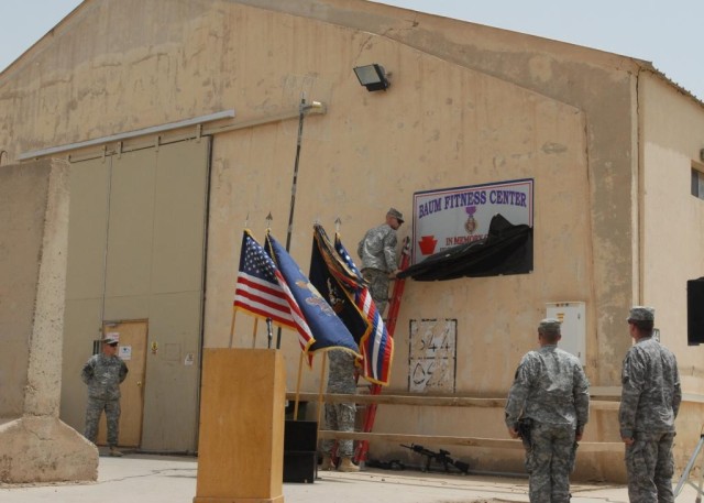 CAMP TAJI, Iraq -Soldiers from 1st Battalion, 111th Infantry Regiment, 56th Stryker Brigade Combat Team, Multi-National Division-Baghdad, unveil the plaque dedicating the Baum Fitness Center.  The gym was named after Staff Sgt. Mark C. Baum, who was ...