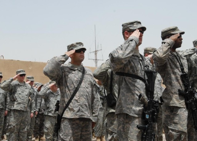 CAMP TAJI, Iraq - Soldiers from 3rd Platoon, Company B, 1st Battalion, 111th Infantry Regiment, 56th Stryker Brigade Combat Team, salute during the dedication of the Baum Fitness Center.  Staff Sgt. Mark Baum, a member of 3rd Platoon, was killed in a...