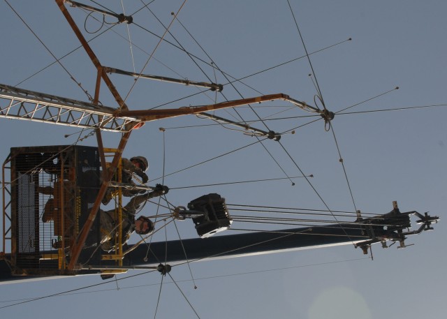 CAMP TAJI, Iraq - Spc. Shawna Teer (left), of Dallas, Pa., and Spc. Kyle Adamski, of Duryea, Pa., both with Headquarters and Headquarters Company, 56th Stryker Brigade Combat Team, perform maintenance to a radio antenna, June 4. The routine...