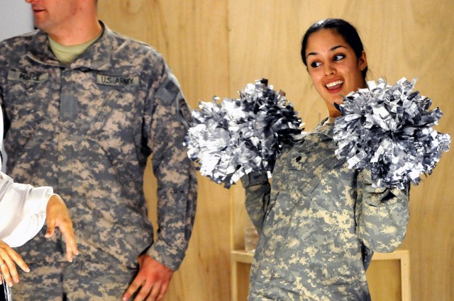 BAGHDAD -Spc. Ikram Mansori, of San Francisco, Calif., assigned to Headquarters and Headquarters Company, 3rd Brigade Combat Team, 82nd Airborne Division, Multi-National Division - Baghdad, does her best cheerleader impression during the...