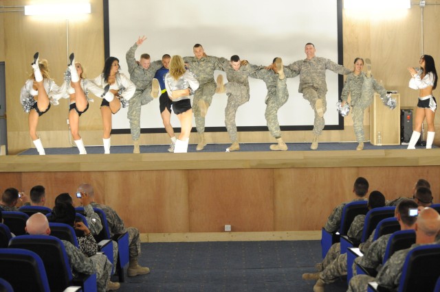 BAGHDAD- Paratroopers assigned to the 3rd Brigade Combat Team, 82nd Airborne Division, Multi-National Division-Baghdad, dance with cheerleaders from the NFL's Oakland Raiders June 4 during a Morale, Welfare and Recreation event at Joint Security...