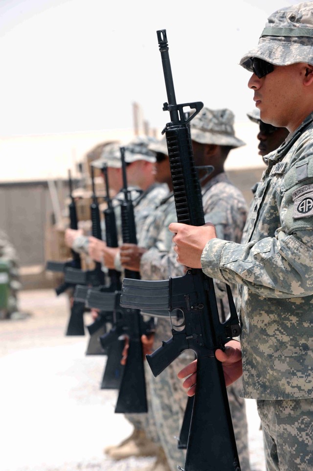 BAGHDAD - Paratroopers of the 3rd Brigade Combat Team, 82nd Airborne Division, Multi-National Division-Baghdad stand in attention as they prepare to fire the volleys for Sgt. Justin Duffy, June 7, at Joint Security Station Loyalty. Duffy served as...