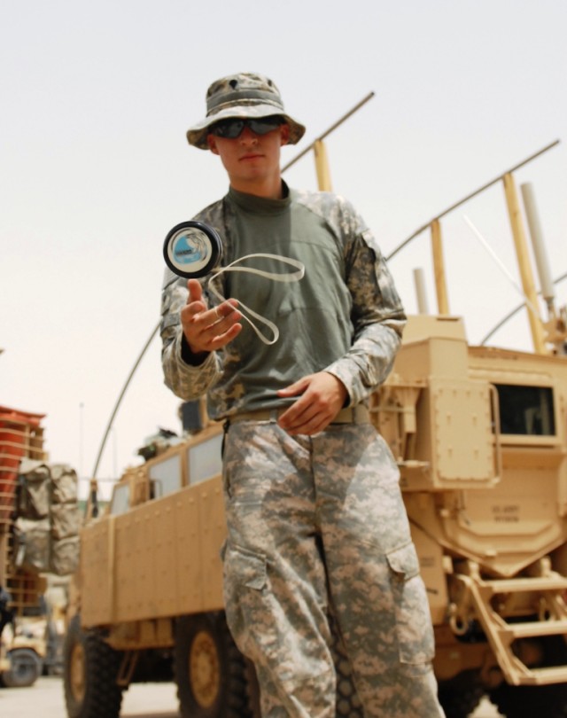 BAGHDAD -Spc. Michael Cox, of Hermitage, Ark., passes time outside of Salam Palace in Baghdad by perfecting yo-yo tricks, June 6. The 225th Engineer Brigade personnel security detachment member said that although he was accomplished with the yo-yo...