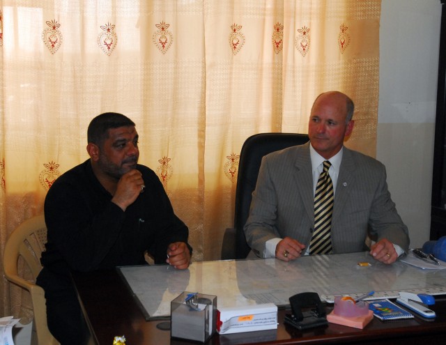 Tim Moore (right) of the U.S. Agency for International Development meets with the Laylan, Iraq mayor during a visit to the Laylan Roman Primary School to verify new construction efforts as part of a combined project between Agricultural...