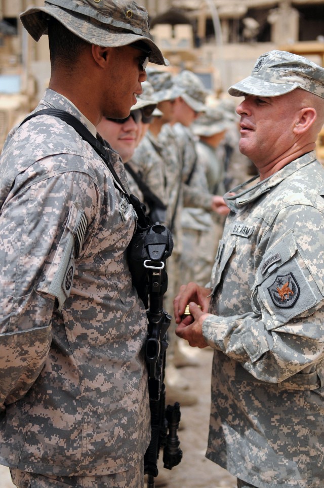 BAGHDAD - Command Sgt. Maj. Lawrence Wilson (right), top enlisted leader of the Multi-National Forces-Iraq, speaks with Paratroopers assigned to the Brigade Special Troops Battalion, 3rd Brigade Combat Team, 82nd Airborne Division, Multi-National Div...