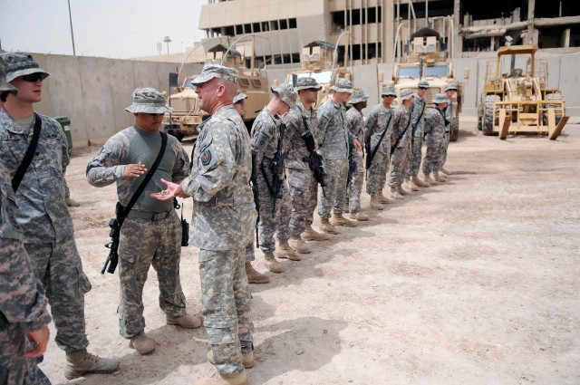 BAGHDAD - Command Sgt. Maj. Lawrence Wilson (right), top enlisted leader of the Multi-National Forces-Iraq, presents his coin of achievement to Paratroopers assigned to the Brigade Special Troops Battalion, 3rd Brigade Combat Team, 82nd Airborne Divi...