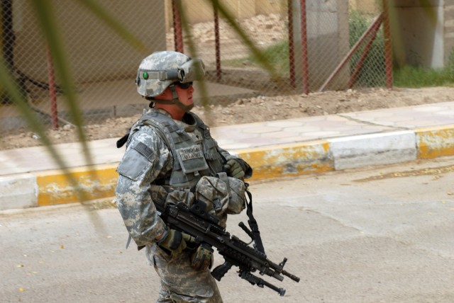 BAGHDAD - Spc. Jon Stricklin, a squad automatic weapon gunner and personal security detail member from Greenville, N.C., assigned to Company A "Anvils," 252nd Combined Arms Battalion, 30th Heavy Brigade Combat Team, escorts his company commander to a...