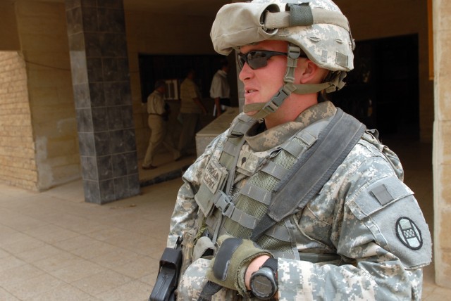 BAGHDAD - Stockbridge, Wis., native, Joseph Vandenboom, an infantryman team leader also assigned as a PSD member, A Co., 252nd CAB, 30th HBCT, talks with an Iraqi teenager in the East al-Rashid District, here, June 9. "We keep the company commander o...