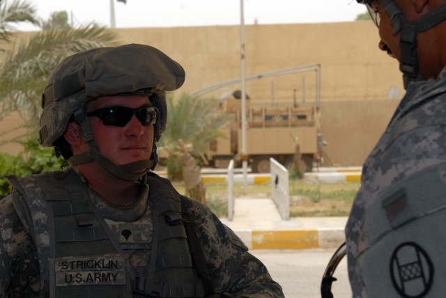 BAGHDAD - Spc. Jon Stricklin, a squad automatic weapon gunner from Greenville, N.C., is replaced on guard by Spc. Jonathan Hernandez, an infantryman from Bronx, N.Y., both PSD members assigned to A Co., 252nd CAB, 30th HBCT. The Soldiers, assigned to...