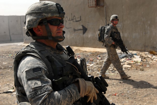 BAGHDAD - Sgt. Jason Traywick (left), a forward observer from Marshville, N.C., and Spc. Justin Davis (right), an infantryman from Walkertown, N.C., both assigned to Company A, 252nd Combined Arms Battalion, 30th Heavy Brigade Combat Team, clear a...