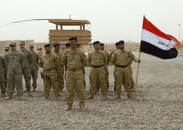 BAGHDAD - Iraqi Soldiers serving with the 1st Battalion, 22nd Brigade, 6th Iraqi Army Division (center) stand in formation among  Soldiers serving with the 1st Combined Arms Battalion, 18th Infantry Regiment, 2nd Heavy Brigade Combat Team, 1st...