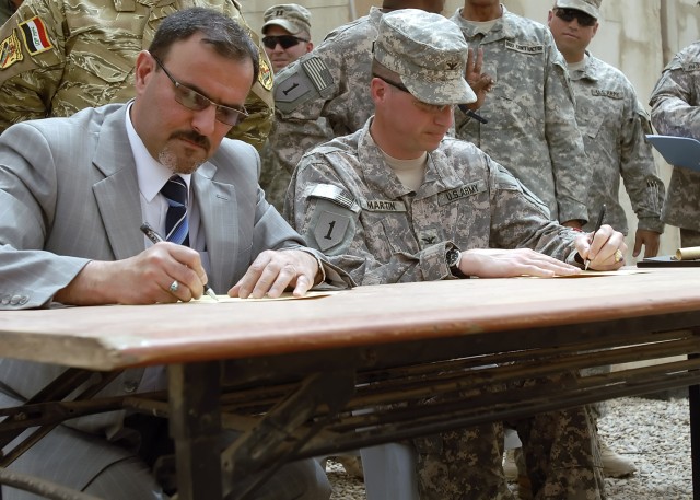 BAGHDAD - Col. Joseph Martin (right), a native of Dearborn, Mich., commander, 2nd Heavy Brigade Combat Team, 1st Infantry Division, Multi-National Division-Baghdad, and Samir Haddad, a representative of the Office of the Prime Minister of Iraq,...