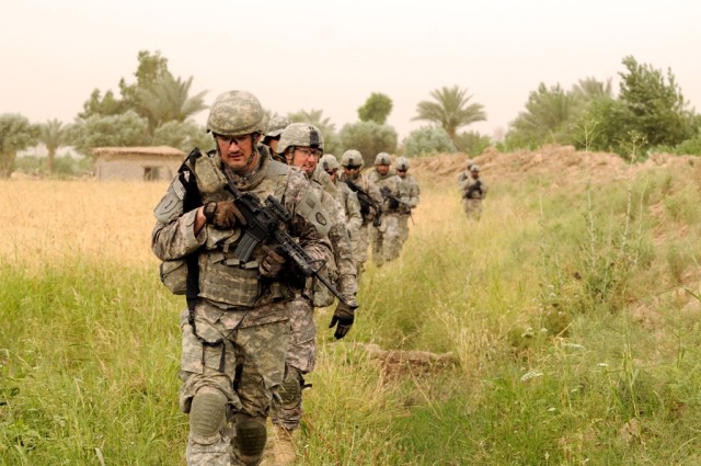 BAGHDAD - Monroe, N.C. native, Sgt. Jonathan Hinson is followed by a group of fellow Soldiers with Battery B, 1st Battalion, 113th Field Artillery Regiment, 30th Heavy Brigade Combat Team, while on a patrol south of Baghdad, June 9. The patrol was...