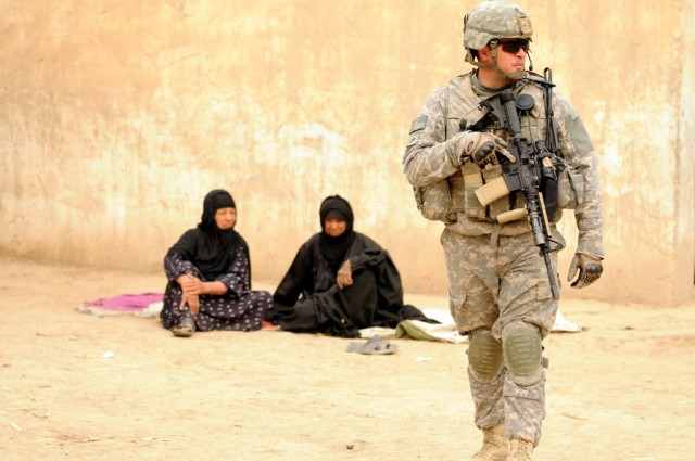 BAGHDAD - Staff Sgt. Brian Dawson, of Winston Salem, N.C., waits for other Soldiers of Battery B, 1st Battalion, 113th Field Artillery Regiment, 30th Heavy Brigade Combat Team, to catch up while on patrol south of Baghdad, June 9. Iraqi Army...