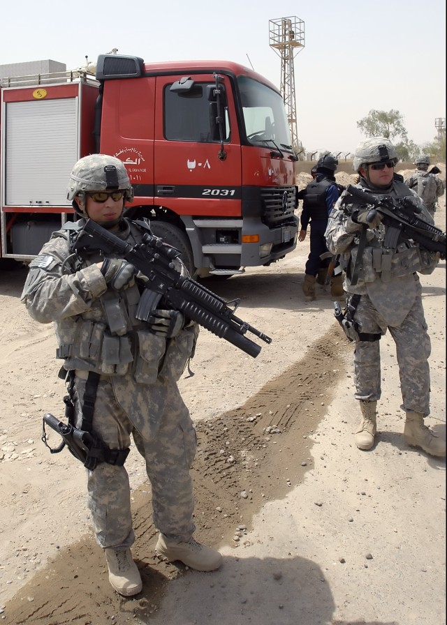 BAGHDAD - Sgt. Jason Powell, a native of Fort Lauderdale, Fla., assigned to a personal security detachment with the 2nd Heavy Brigade Combat Team, 1st Infantry Division, Multi-National Division - Baghdad, helps secure the surrounding area of the...