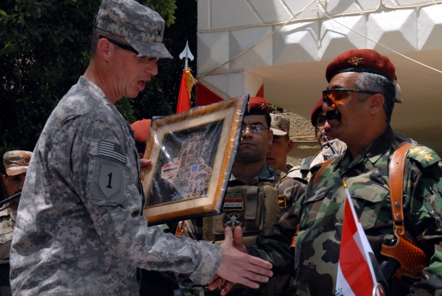 BAGHDAD - Col. Joseph Martin, a Dearborn, Mich., native and commander of the 2nd Brigade Combat Team, 1st Infantry Division, accepts a gift on behalf of his Soldiers from Col. Khaim Rusin Rahim, commander of the 3rd Battalion, 54th Army Brigade,...