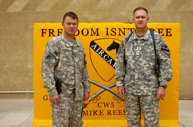 TAJI, Iraq - Chief Warrant Officer Michael Reese (left), brigade standardizations instructor pilot, 1st Air Cavalry Brigade, 1st Cavalry Division, Multi-National Division - Baghdad and Chief Warrant Officer Scott McLendon, brigade safety officer,...
