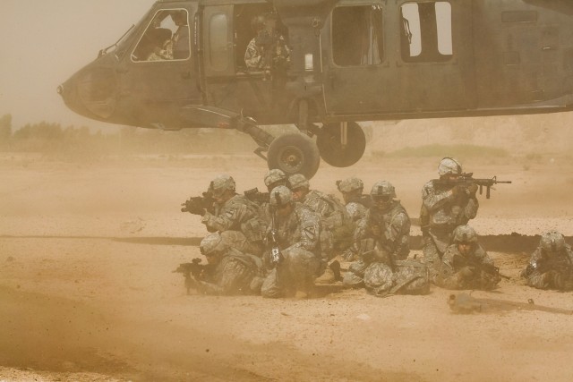 TAJI, Iraq - During a downed aircraft training exercise, Soldiers from Company F, 3rd Battalion, 1st Air Cavalry Brigade, 1st Cavarly Division, Multi-National Division - Baghdad, pull security after dismounting a UH-60 Black Hawk helicopter at...