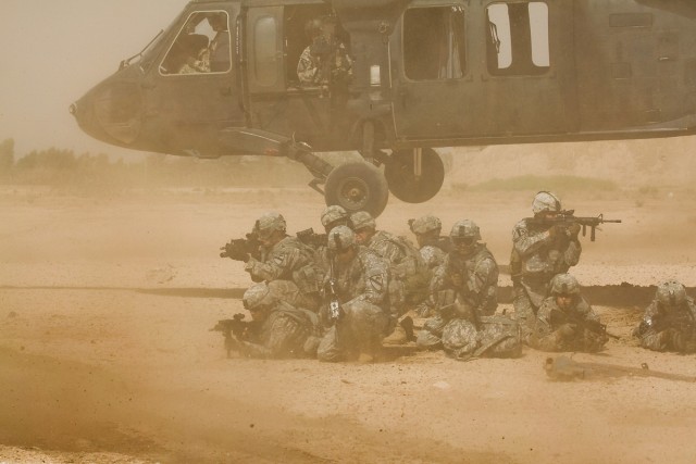 TAJI, Iraq - During a downed aircraft training exercise, Soldiers from Company F, 3rd Battalion, 1st Air Cavalry Brigade, 1st Cavarly Division, Multi-National Division - Baghdad, pull security after dismounting a UH-60 Black Hawk helicopter at Camp T...