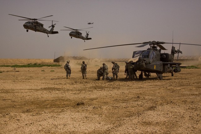 TAJI, Iraq - During a downed aircraft training exersice, Soldiers of Company F, 3rd Battalion, 1st Air Cavalry Brigade, 1st Cavarly Division, Multi-National Division - Baghdad, go through the motions of treating the pilots as two UH-60 Black Hawk Hel...