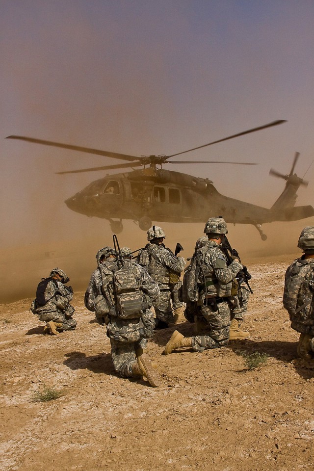 TAJI, Iraq - After completing a downed aircraft training exercise, Soldiers from Company F, 3rd Battalion, 1st Air Cavalry Brigade, 1st Cavalry Division, Multi-National Division - Baghdad, wait for a UH-60 Black Hawk helicopter to land before loading...