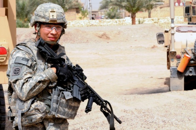 BAGHDAD - Pfc. Gregory Castro, of Rancho Cucamonga, Calif., checks his surroundings and provides security outside of the civil support district center June 11 in the city of Shawa Wa Um Jidir, located in 9 Nissan District of eastern Baghdad. The...