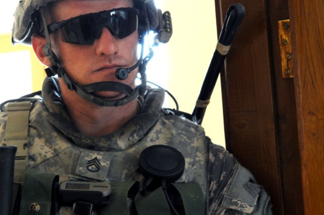 BAGHDAD - Staff Sgt. Michael D. Mathieu, of Fayetteville, N.C., listens to Iraqi leaders in the city of Shawa Wa Um Jidir, located in the 9 Nissan District of eastern Baghdad June 11. City officials and Paratroopers assigned to Company B, 2nd...