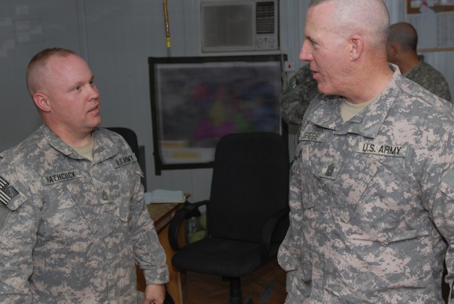 BAGHDAD - Sgt. 1st Class Cary Hathcock (left), a native of Albemarle, N.C., and the operations noncommissioned officer assigned to Company A, 252nd Combined Arms Battalion, 30th Heavy Brigade Combat Team, talks with Command Sgt. Maj. Frank Grippe,...