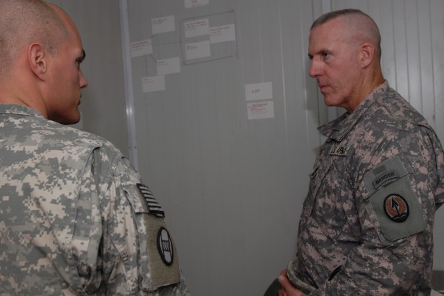 BAGHDAD - Charlotte, N.C., native, Staff Sgt. Derek Easley (left), a forward observer and an intelligence noncommissioned officer, assigned to Company A, 252nd Combined Arms Battalion, 30th Heavy Brigade Combat Team, gives an intelligence briefing...