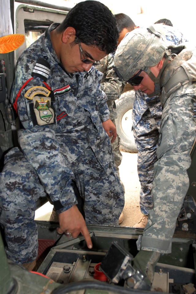 BAGHDAD - "I have more knowledge with the vehicle and I feel comfortable now," said Sgt. Saefe Fadhel Nassir (left), the commander's driver, assigned to 1st Company, 3rd Battalion, 7th Brigade, 2nd National Police Division, as he points out a...