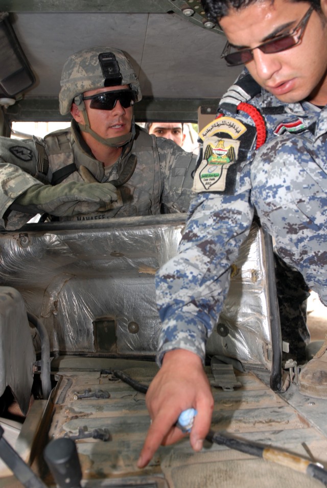 BAGHDAD - Sgt. Adam Mahaffey (left), an infantryman from North Wilkesboro, N.C., assigned to Company A, 252nd Combined Arms Battalion, 30th Heavy Brigade Combat Team, gives maintenance tips to Sgt. Saefe Fadhel Nassir (right), assigned to 1st Co.,...
