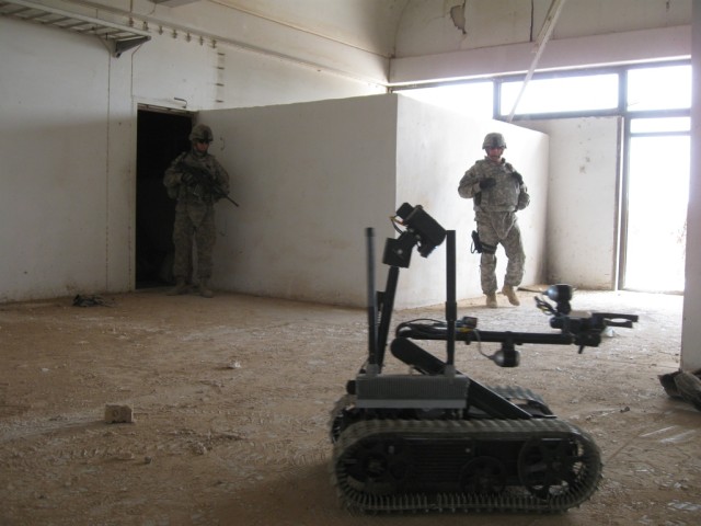 BAGHDAD-Sgt. 1st Class Bruce Mcrae (right) of San Antonio, Texas and Staff Sgt. James Bohanon (left) of Belleville, Ill., supervise an explosive ordinance disposal robot as it is controlled remotely by Iraqi Security Forces Soldiers in training.  Mcr...