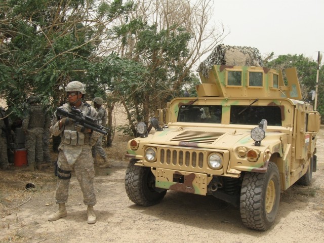 BAGHDAD-Sgt. Jason Graham, of Covina, Ca., stands guard while explosives ordnance detachment Soldiers of the 1st Brigade Special Troops Battalion, 1st "Ironhorse" Brigade Combat Team, 1st Cavalry Division conduct a joint training session with Lt. Moh...