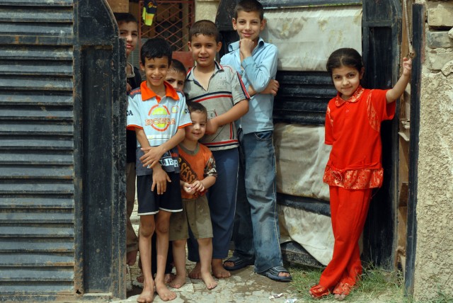 BAGHDAD - Iraqi children watch as Soldiers of the North Carolina National Guard's "Old Hickory Brigade" pull security duty in the Doura neighborhood, here, June 12. The Soldiers of Company A, 252nd Combined Arms Battalion, 30th Heavy Brigade...