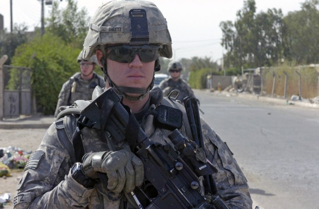 BAGHDAD - Sgt. Richard Sheetz, of Galloway, N.J., keeps an eye for any suspicious activity during a foot patrol June 13 along a major highway in the 9 Nissan district of eastern Baghdad. Sheetz, a team leader, and Paratroopers assigned to the Militar...