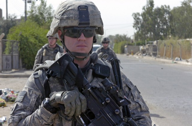 BAGHDAD - Sgt. Richard Sheetz, of Galloway, N.J., keeps an eye for any suspicious activity during a foot patrol June 13 along a major highway in the 9 Nissan district of eastern Baghdad. Sheetz, a team leader, and Paratroopers assigned to the...