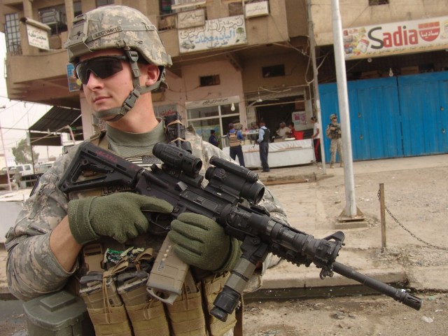 BAGHDAD – Pfc. Nathan LeCompte, of B Company, 252nd Combined Arms Battalion, 30thHeavy Brigade Combat Team, guards a marketplace in the Saydiyah district of southern Baghdad, as Iraqi Police and fellow U.S. Soldiers patrol, June 9. LeCompte is...